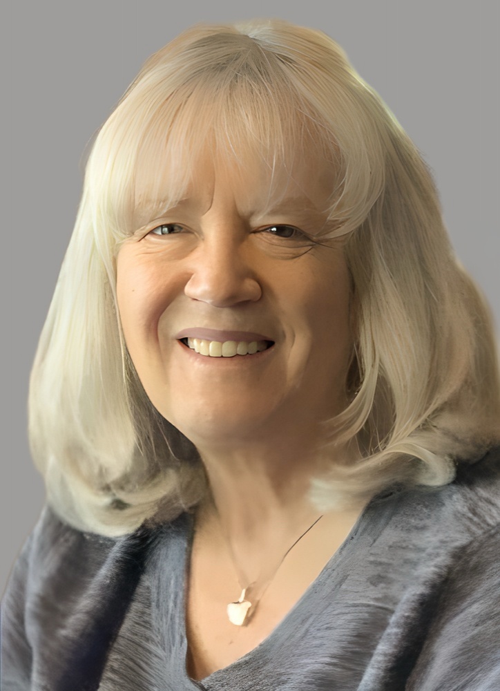 woman with white hair, grey top and heart lcoket