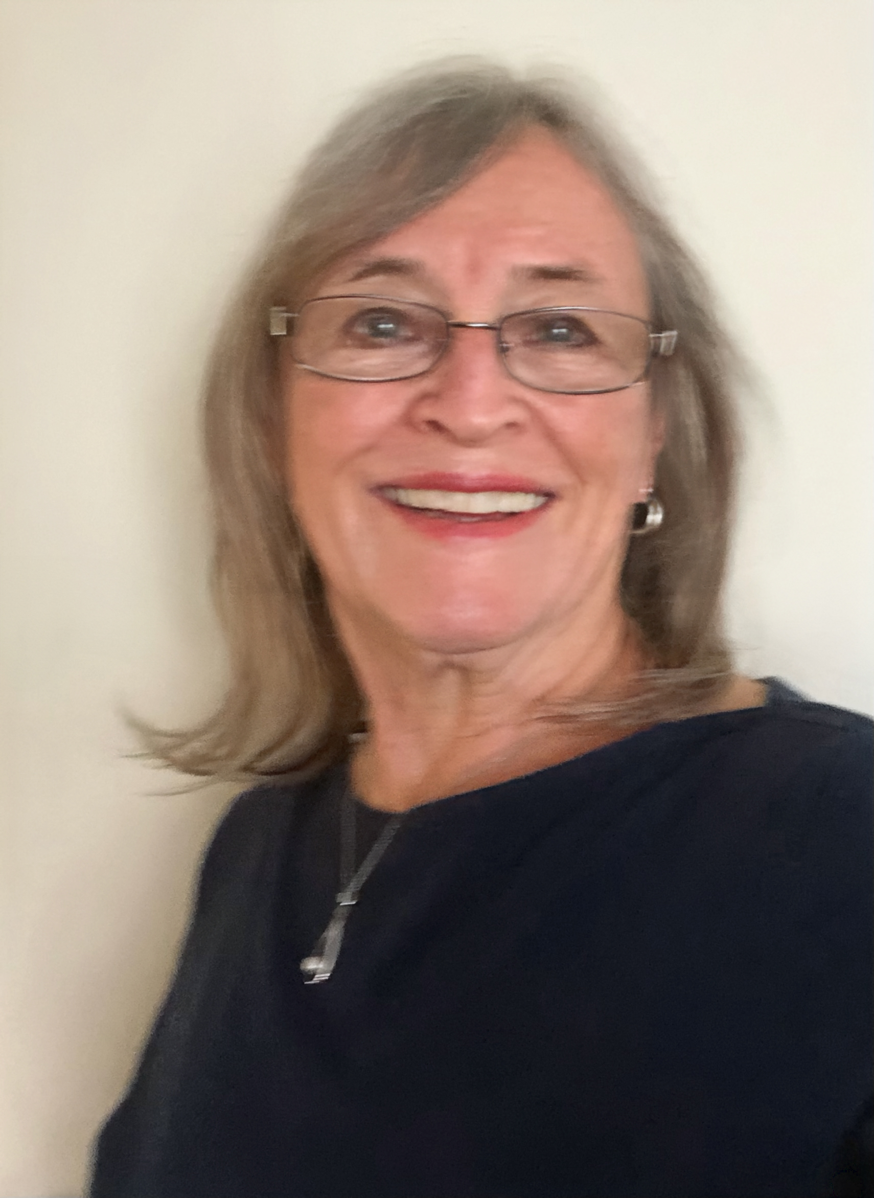 woman with glasses and blue shirt