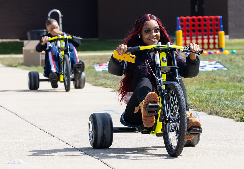 students riding trikes at mental health day