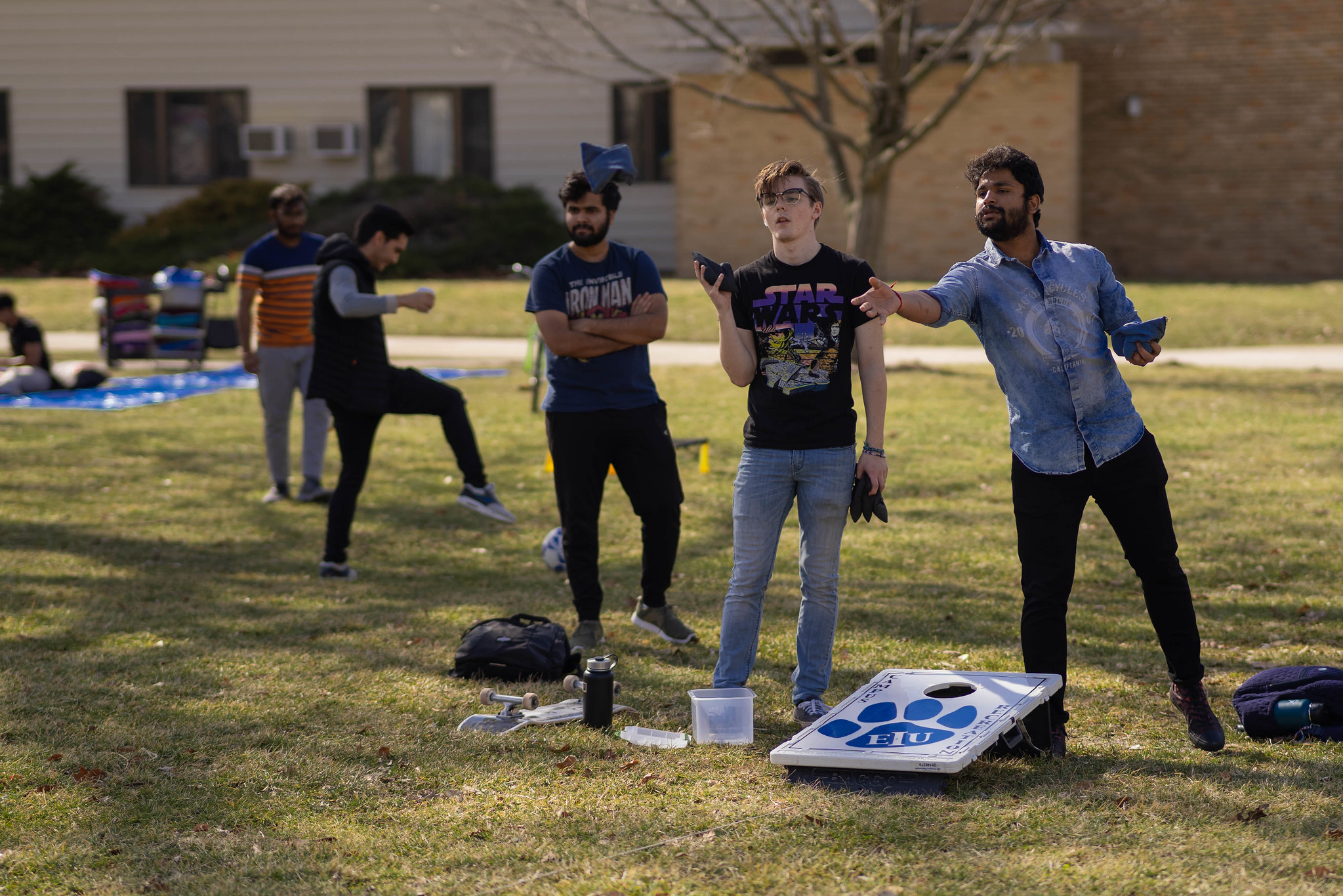 students playing bags in the quad
