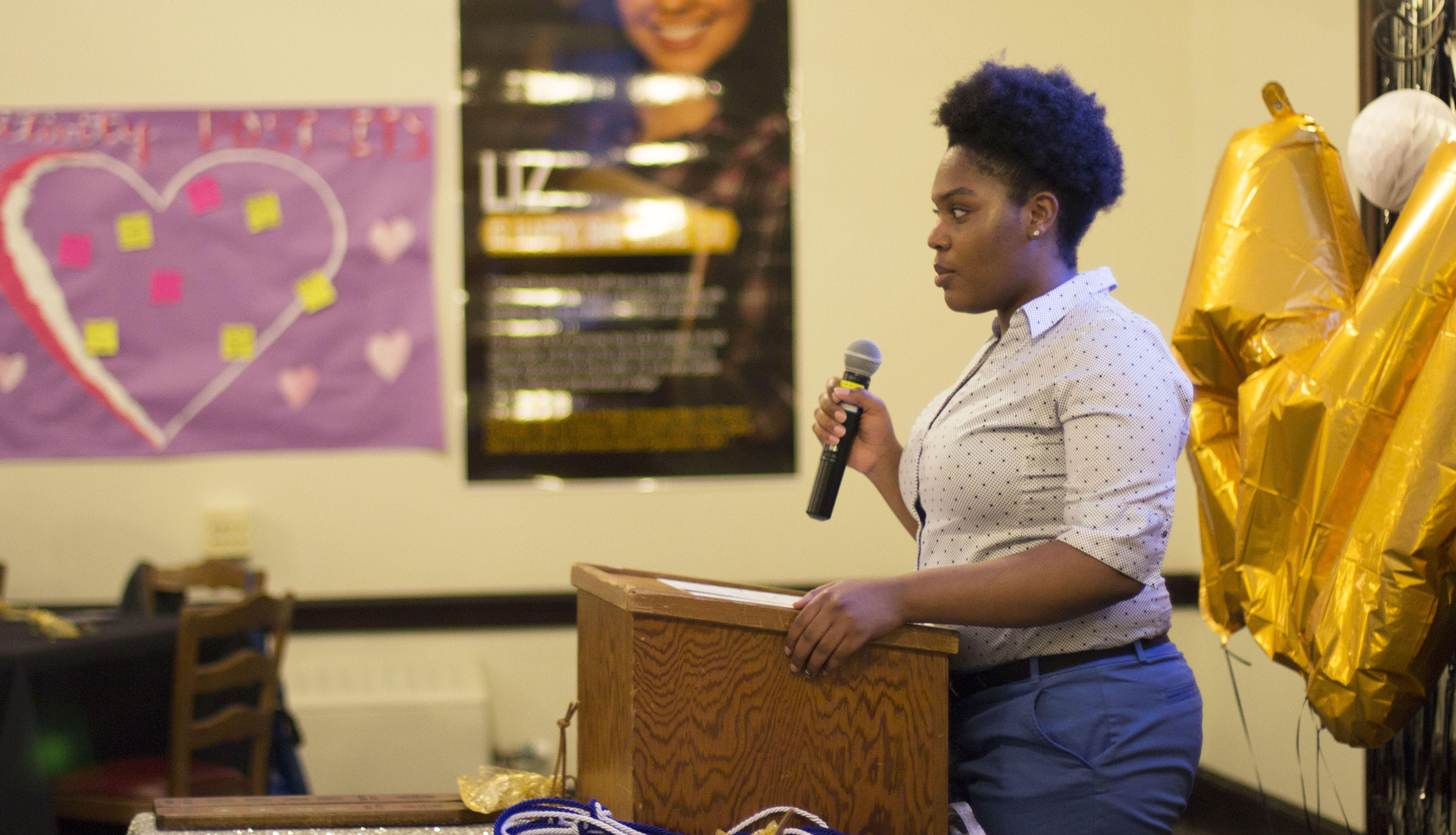 Student standing with mic in hand