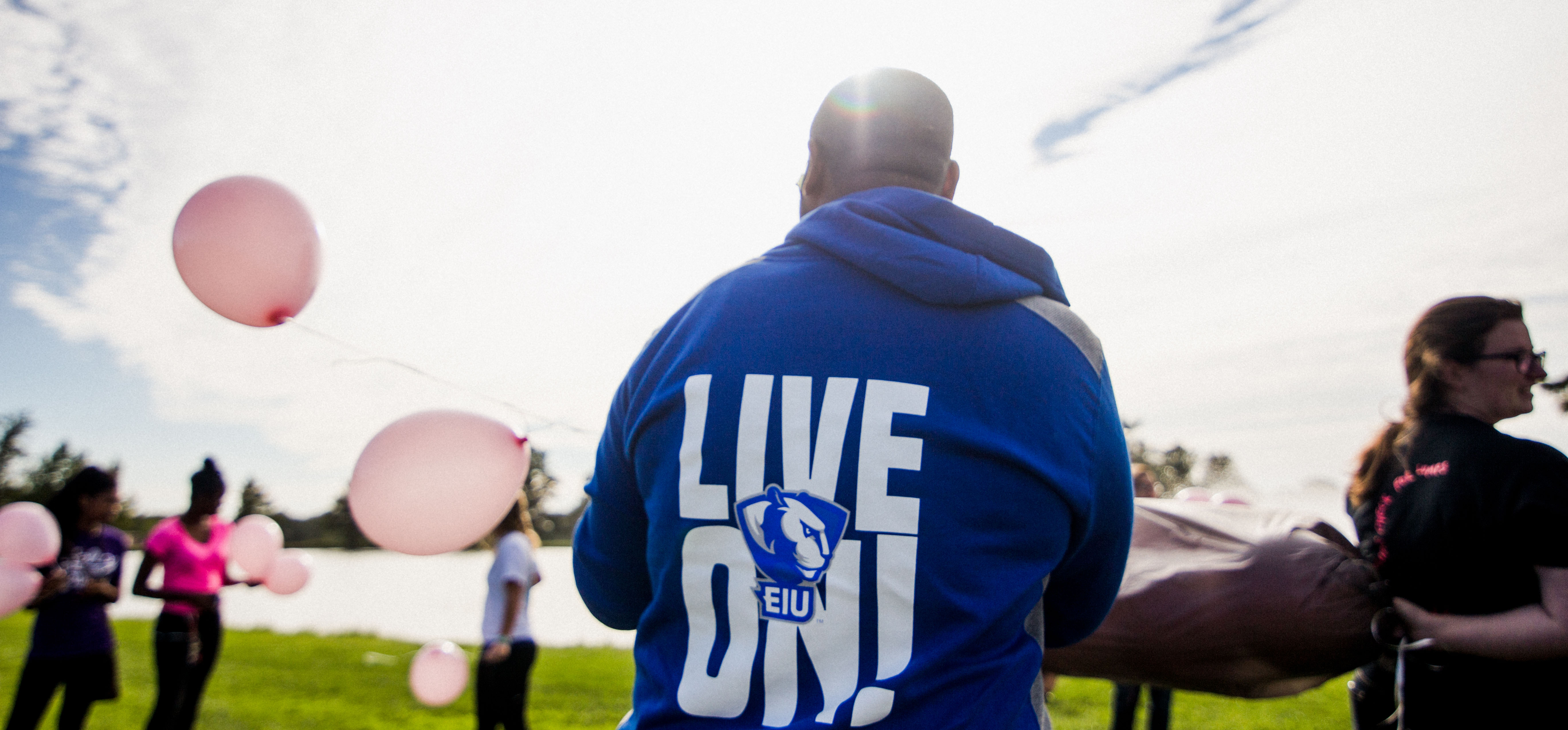 Student in Live On jacket releasing balloons for BAC week