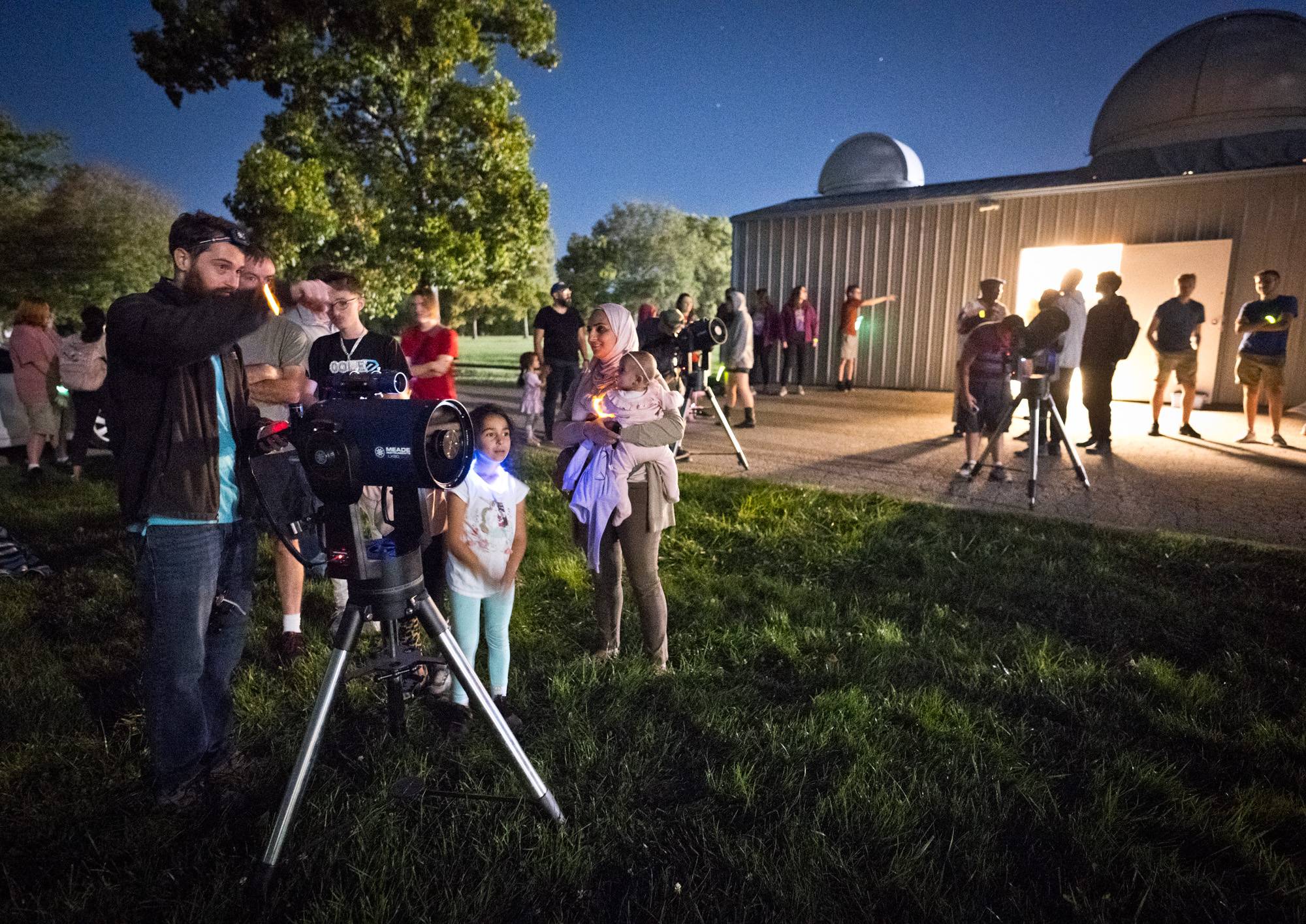 Dr. Strausbaugh explaining how to look through telescopes on open house night. Photo courtesy of Greg Cooper.