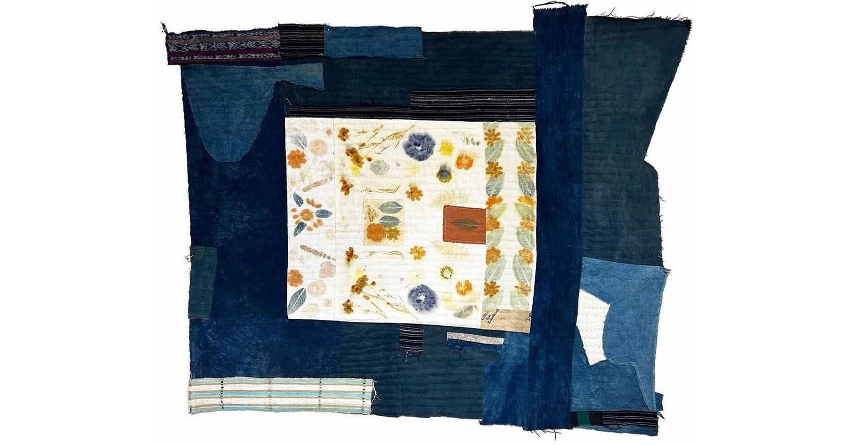 picture of a sewn together denim square with flowers in the middle